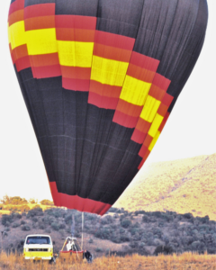 An early Bill Harrop hot air balloon being inflated in the Magaliesberg during the pioneering years of commercial ballooning in South Africa.