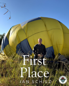 First-place winner Ian Schilz standing beside his balloon at the Winter Fun Flight Fest 2026