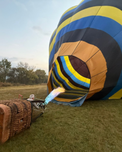 Hot air balloon pilot inflating a commercial balloon before sunrise in South Africa