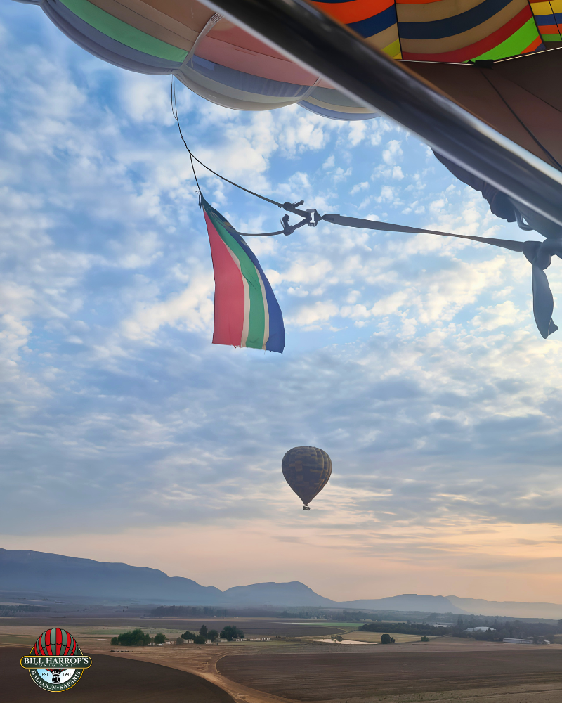 South African flag suspended from a hot air balloon above the Magalies River Valley