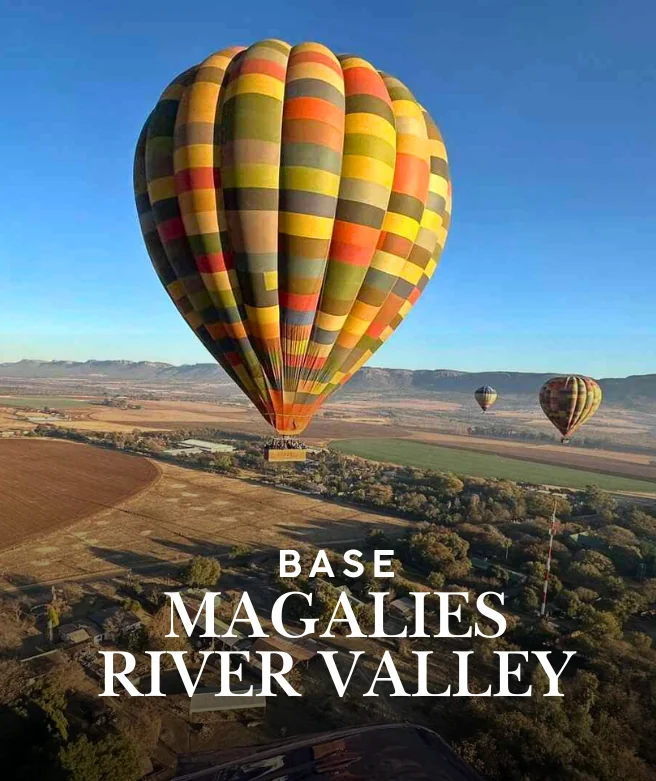 Hot air balloons flying over the Magalies River Valley near Hartbeespoort, South Africa.