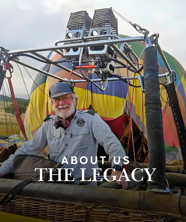 Bill Harrop in a hot air balloon basket, celebrating the legacy of Bill Harrop's Original Balloon Safaris.